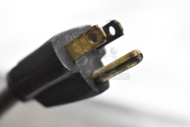 Close-up of a power plug for Bunn G-9 Commercial Coffee Bean Grinder, showing its prongs and detailing.