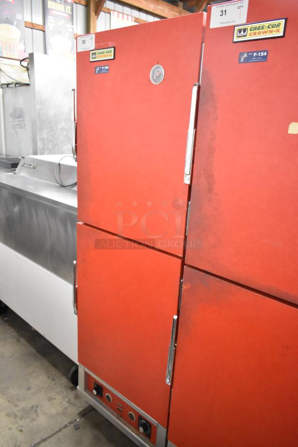 Cres-Cor H1381834 heated holding cabinet with red metal exterior on casters. Features temperature dial and brand label, 120V, 1 phase.