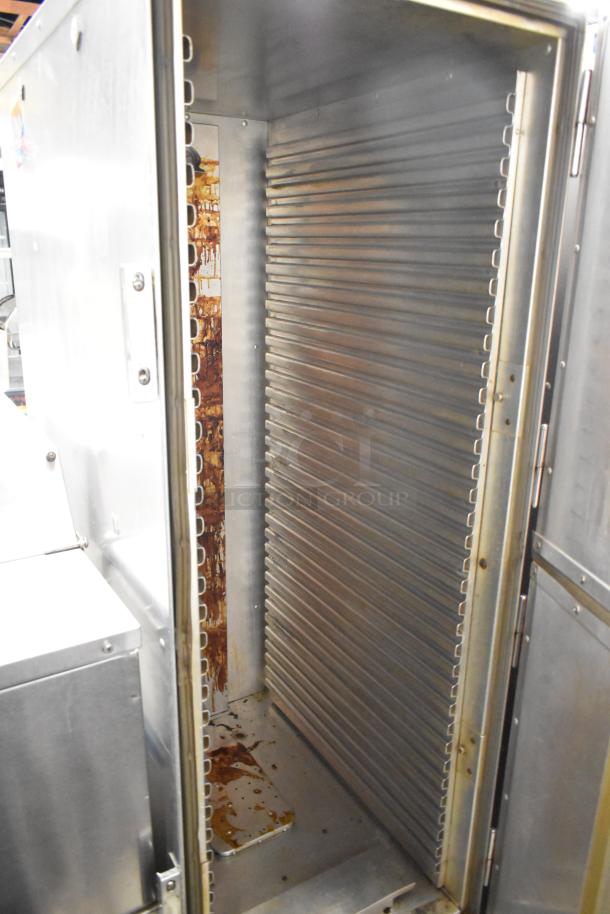 Cres-Cor H1381834 heated holding cabinet, metal finish, on casters. Interior with shelving racks, visible wear inside. 120V, 1 phase.