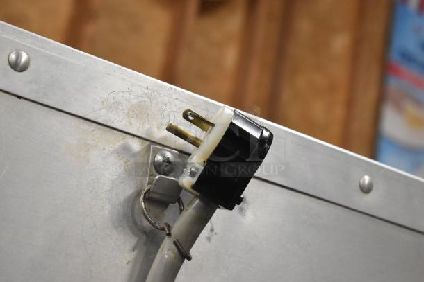 Cres-Cor H1381834 metal heated holding cabinet plug detail. 120V, 1 phase, commercial casters. Visible wear on plug area.
