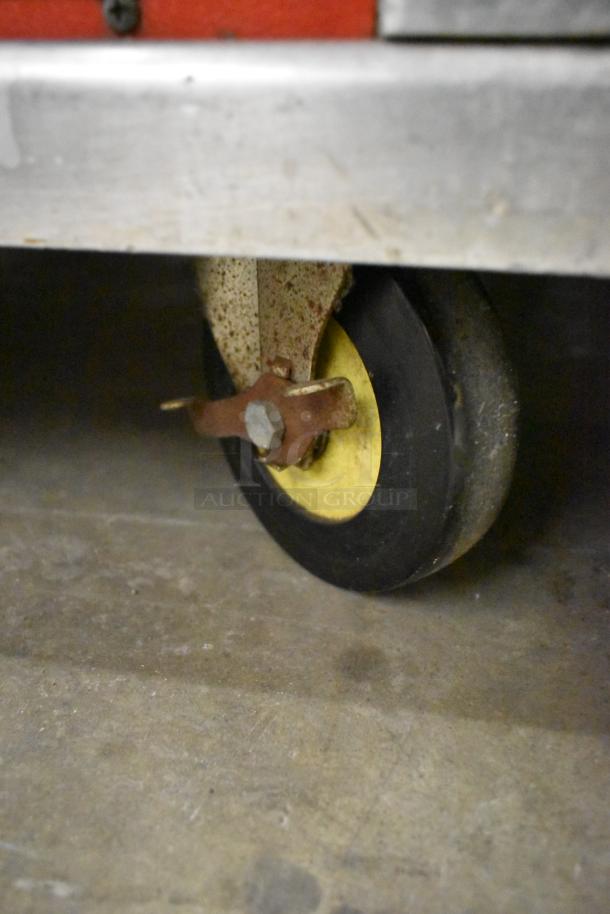 Cres-Cor H1381834 heated holding cabinet caster detail, showing sturdy commercial caster, slight wear visible.