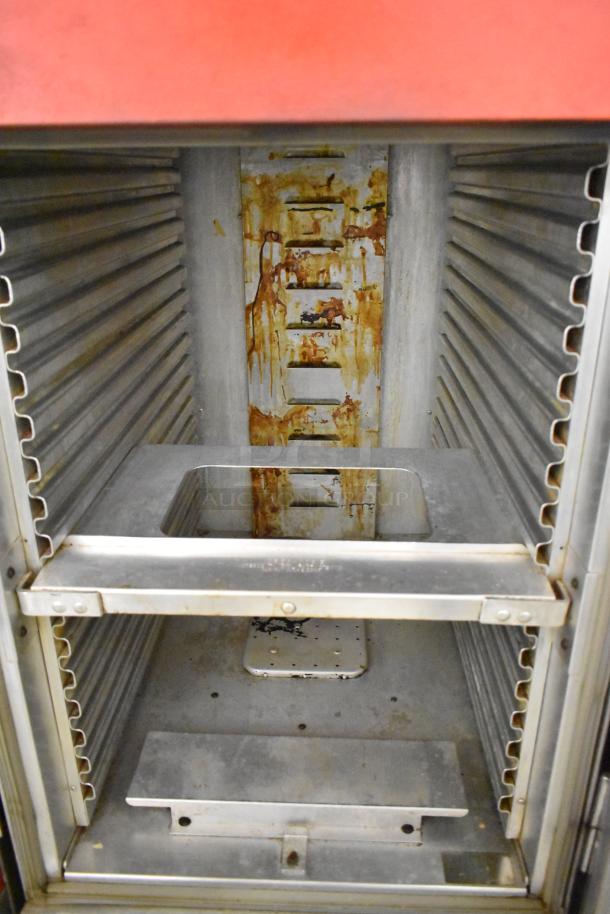 Cres-Cor H1381834 heated holding cabinet, metal interior, visible rust and wear, on casters, 120V, 1 phase.