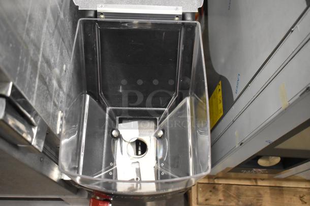 Grindmaster Grind'n Brew-10H coffee grinder and maker, stainless steel, with a clear bean hopper and metal brew basket.