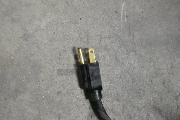 Power plug for Grindmaster Grind'n Brew-10H commercial coffee maker, showing standard three-prong configuration.