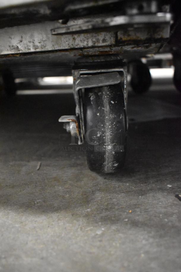 Worn caster wheel on Turbo Air M3F24-1 stainless steel commercial freezer, part of the mobility system; 115 volts, 1 phase.