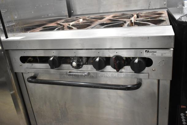 Southbend 1364D stainless steel commercial 4-burner range, natural gas, with oven and backsplash; visible wear.