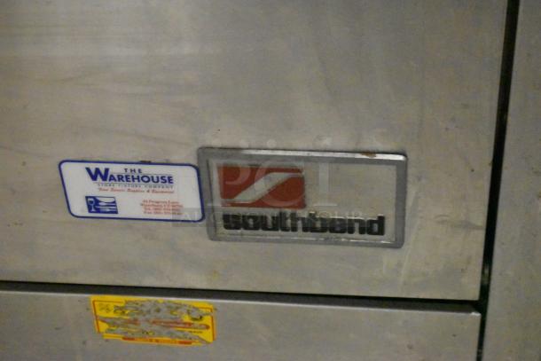 Southbend 1364D stainless steel commercial range with oven, natural gas powered, features 4 burners and backsplash.