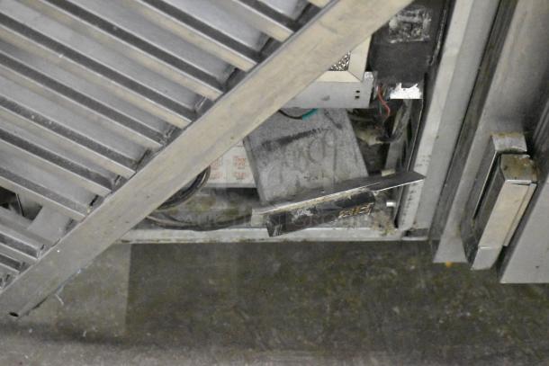 Traulsen UC2HT stainless steel undercounter cooler, two doors, visible wear, 115 volts, 1 phase, commercial use.