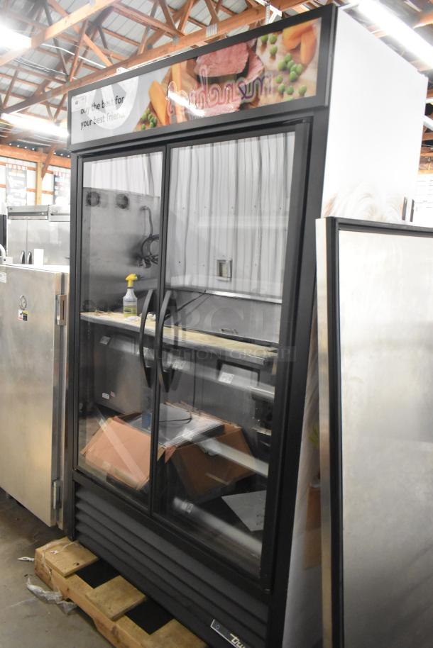 2022 True TVM-48SL-HC 2-door commercial cooler with metal shelves, glass doors, in good condition, 115V, 1 phase.