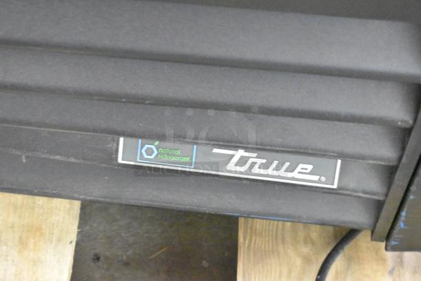 True TVM-48SL-HC commercial 2-door cooler with metal shelves. Natural refrigerant label visible. 115V, 1-phase.