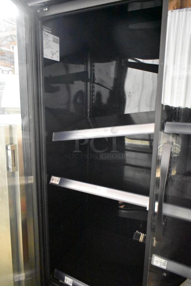 2022 True TVM-48SL-HC commercial 2-door cooler, metal shelves, 115V, 1 phase, pristine interior, serial tag visible.