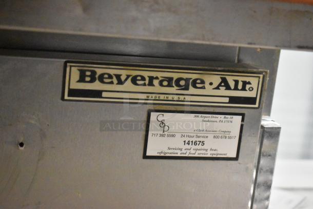 Beverage Air stainless steel prep table with mega top. Includes labels with 24-hour service info and model details.