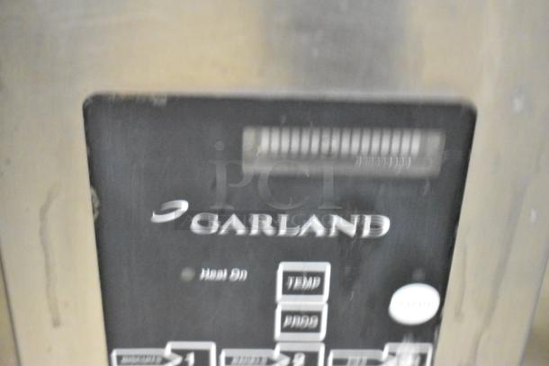 Garland MCOE5LDSMD stainless steel half-size convection oven with solid door, on commercial casters. 208 Volts, 3 Phase.