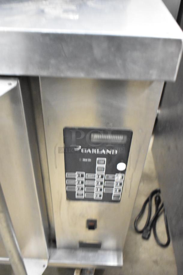 Garland MCOE5LDSMD stainless steel half-size convection oven, solid door, commercial casters, 208V, 3-phase.