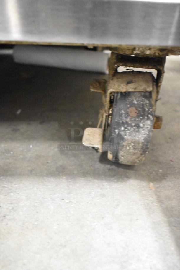 Close-up of a worn caster on a Garland MCOE5LDSMD stainless steel commercial convection oven.