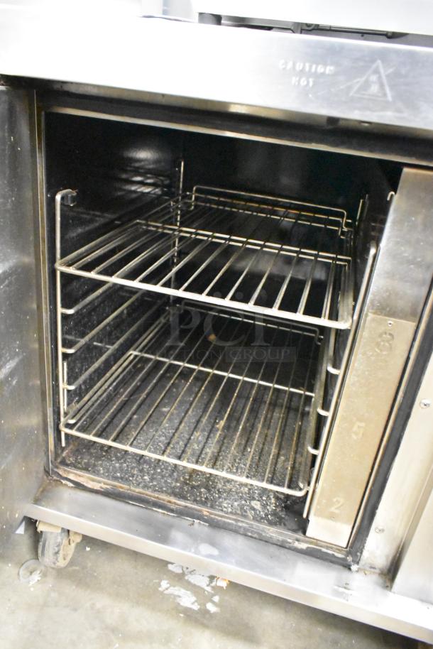 Garland MCOE5LDSMD stainless steel commercial half-size convection oven on casters, solid door, 208V, 3 phase.