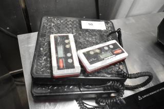 Two Rubbermaid 150-pound capacity scales, used, with digital displays and visible brand labels.