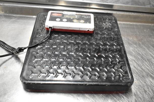 2 Rubbermaid 150 lb capacity scales with textured platforms and control panels, showing some wear.