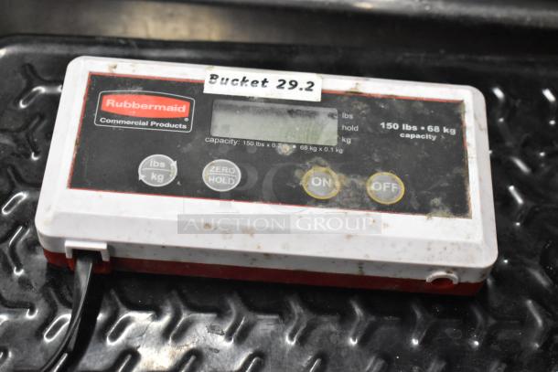 Rubbermaid scale with 150-pound capacity; features on/off buttons, lbs/kg switch, and "Bucket 29.2" label; shows wear.