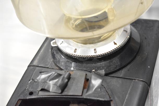 Bregani metal commercial countertop espresso bean grinder, no lid, shows wear. Features 120V, 1 phase, numbered dial settings.