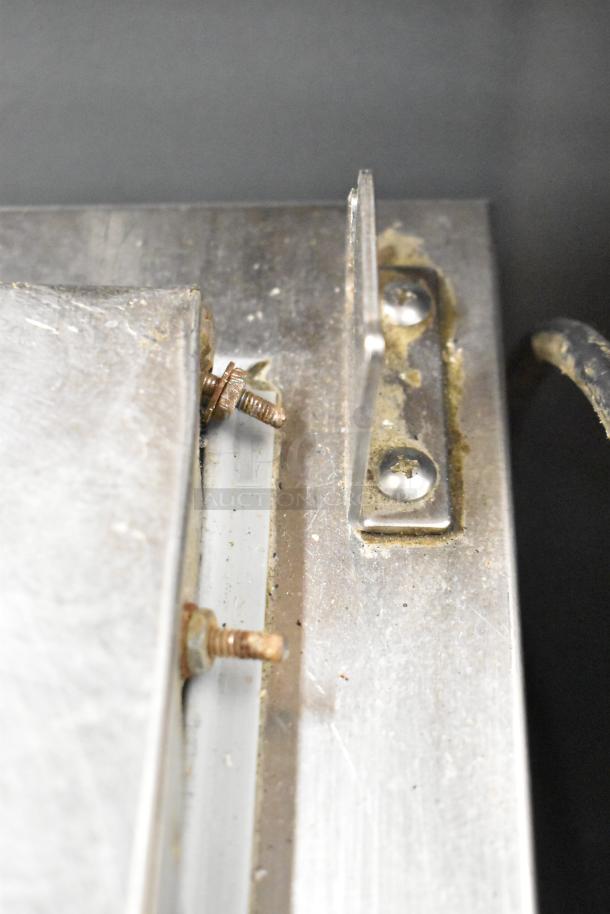 Close-up of the 2017 Continental CPA68 pizza prep table, showing stainless steel surface with screws and mounting bracket.