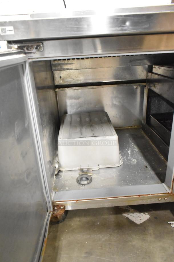 2017 Continental CPA68 stainless steel pizza prep table, interior view with two doors open, on commercial casters.