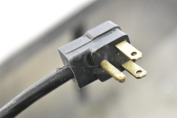 Close-up image of a power plug of the Beverage Air SPE48HC-12C sandwich salad prep table.