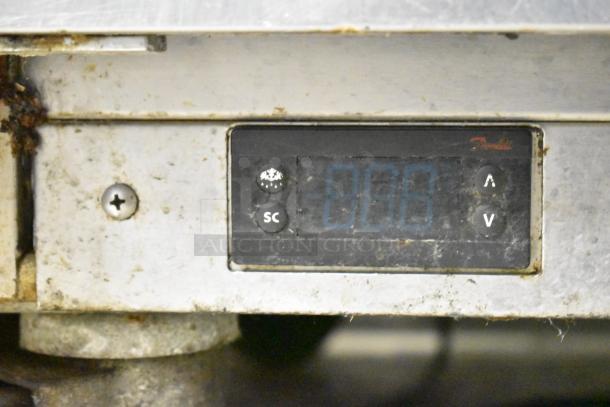 Beverage Air SPE48HC-12C control panel on a stainless steel commercial prep table, showing wear and use.