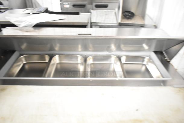 Beverage Air SPE48HC-12C stainless steel prep table with four trays, on commercial casters. 115 volts, 1 phase.