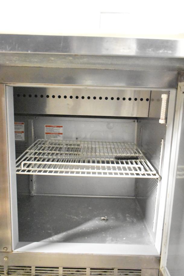 Beverage Air SPE48HC-12C stainless steel prep table interior with wire shelf, commercial casters, 115 volts, 1 phase.