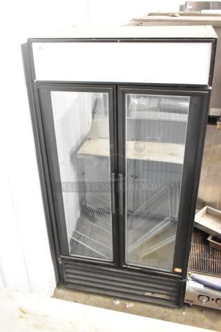 True GDM-35F commercial freezer, 2 glass doors, metal body, poly-coated racks, 115 volts, used condition.