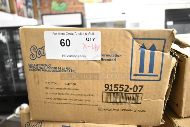 Four unopened boxes containing Purell hand sanitizer dispenser, Scott Foam Skin Cleanser, Aqua Sparkle detergent; auction label indicates QTY 60, 4x bid.