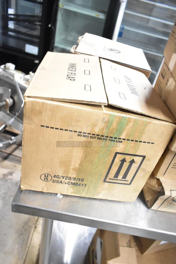 Four brand new boxes containing Purell hand sanitizer dispenser, Scott foam skin cleanser, and Aqua Sparkle detergent.