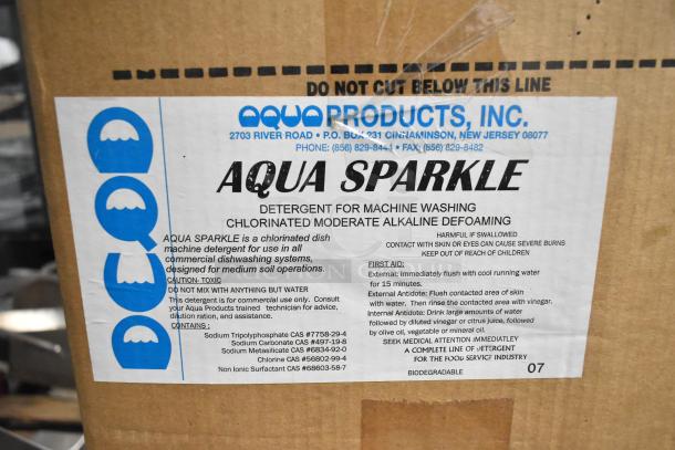 4 brand new boxes including Purell hand sanitizer dispenser, Scott foam skin cleanser, and Aqua Sparkle detergent for machine washing. Aqua Sparkle label details usage and safety information.