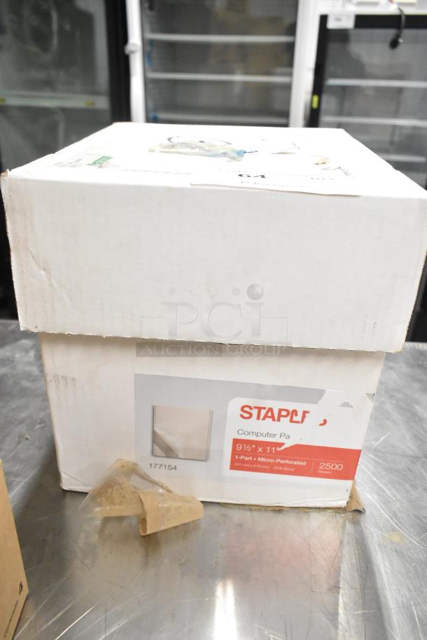 Two brand new boxes including Dymo LabelManager and Staples computer paper, 9.5"x11", 2500 sheets, unopened.