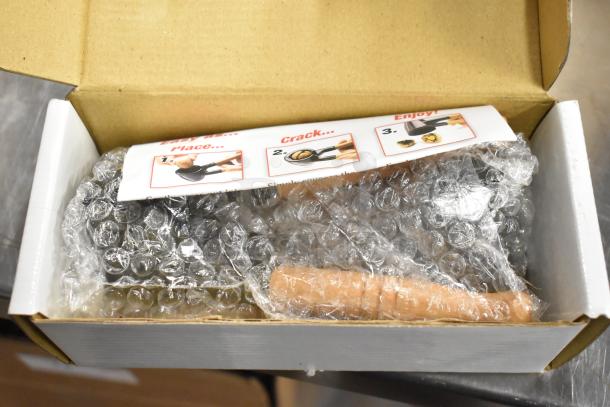 Box of Nut Master Mut Crackers, brand new, in original packaging with instructional label. Includes bubble wrap for protection.