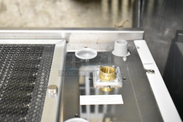 Brand new Manitowoc RFS0650A stainless steel flake ice machine, 682 lb capacity, 220V, 1 phase, visible connector and components.