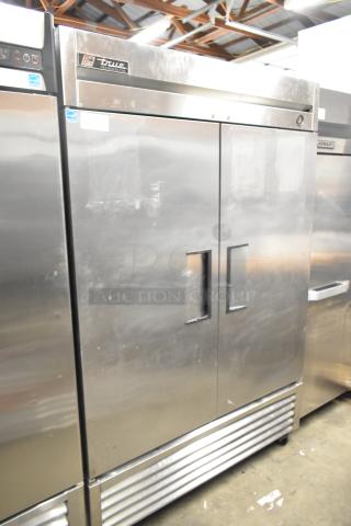 True T-49 stainless steel commercial 2-door cooler with poly coated racks, on commercial casters. 115 volts, 1 phase.