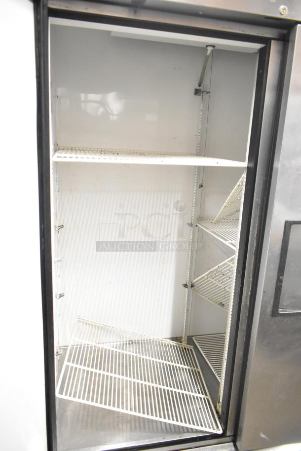 True T-49 stainless steel commercial cooler with two doors, poly coated racks, on casters. 115V, 1 phase; interior view.