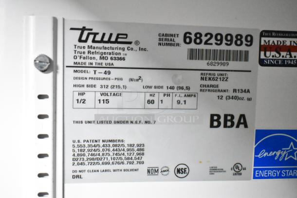 Label on True T-49 cooler showing model, voltage 115, phase 1, refrigerant R134A, and NSF certification. Made in USA.