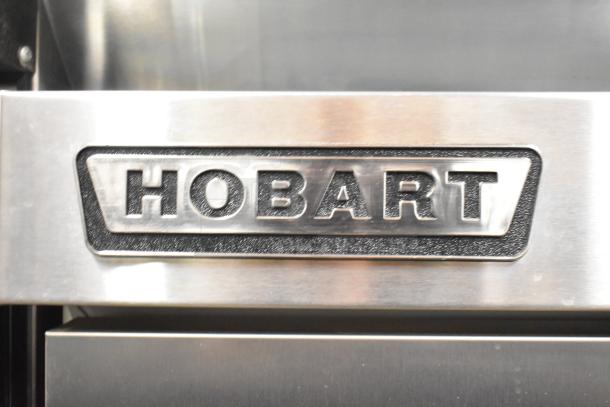 Hobart QF1 stainless steel single door freezer with logo visible. Features poly-coated racks, on commercial casters.