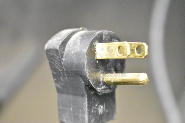 Close-up of a two-prong electrical plug for the Hobart QF1 commercial freezer, showing its connection type.