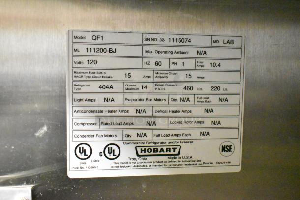 Hobart QF1 stainless steel commercial single door reach-in freezer with poly coated racks on casters, 115V, 1 phase.