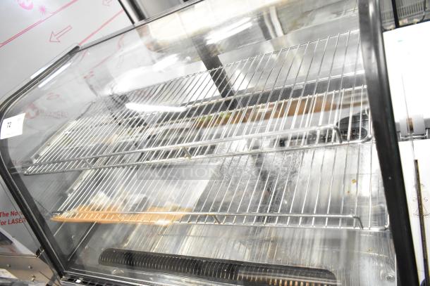 Marchia MDC161 metal countertop deli display case, glass front, 115 volts, 1 phase, two wire shelves, item tag visible.