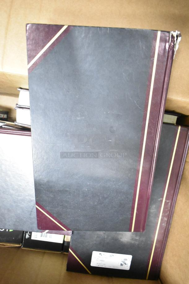 Lot of approximately 25 items including black notebooks with burgundy trim, copy paper reams, and a Lexmark printer cartridge.