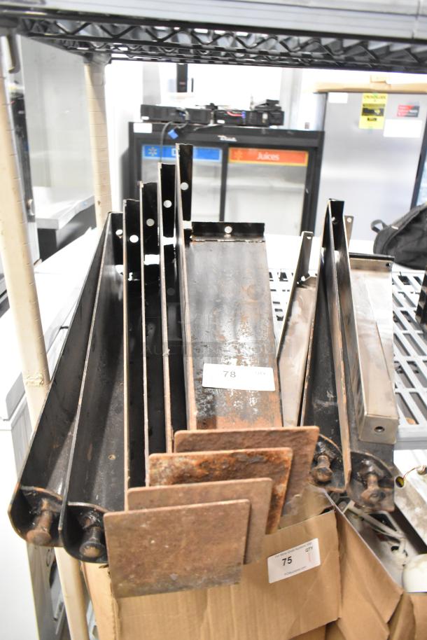 Lot of various metal items including metal legs for convection oven, visible rust, numbered tags "78" and "75."