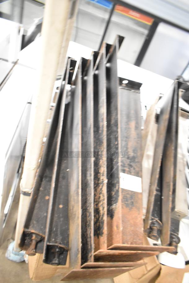 Metal legs for convection oven, showing wear and rust. Part of a tier lot including a gas hose. Auction item with mixed conditions.