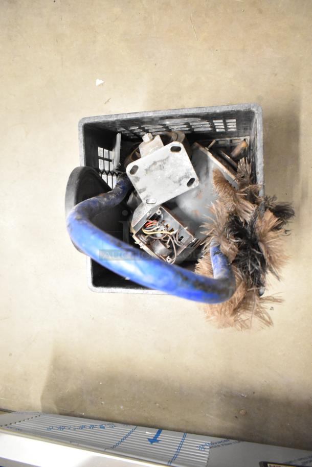 Basket with metal legs for convection oven, gas hose, and assorted items. Key components visible include a gas hose and metal brackets.