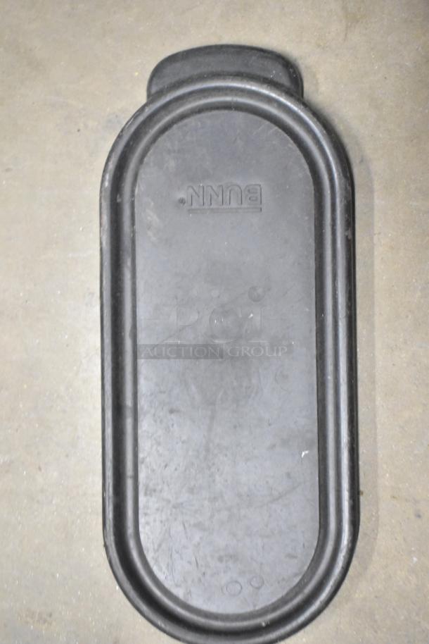 Alt text: BUNN branded black metal tray with oval shape, showing signs of wear. Part of a mixed auction lot.