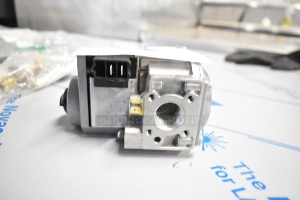 Close-up of a brand new Garland HP4530799 valve for US Range, natural gas use, with visible ports and connectors.